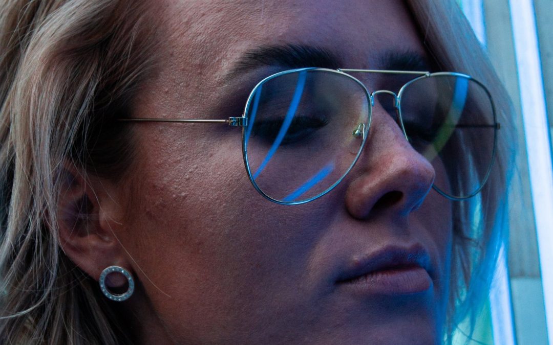 close up photo of woman with glasses and eyes closed